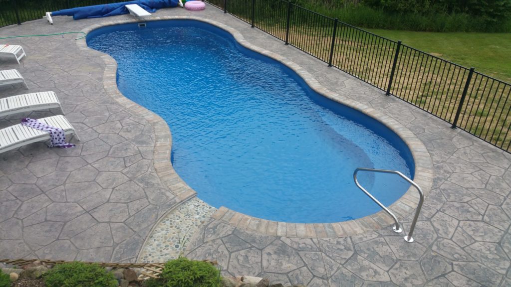 Inground fiberglass pool with Stamped concrete Highland Michigan