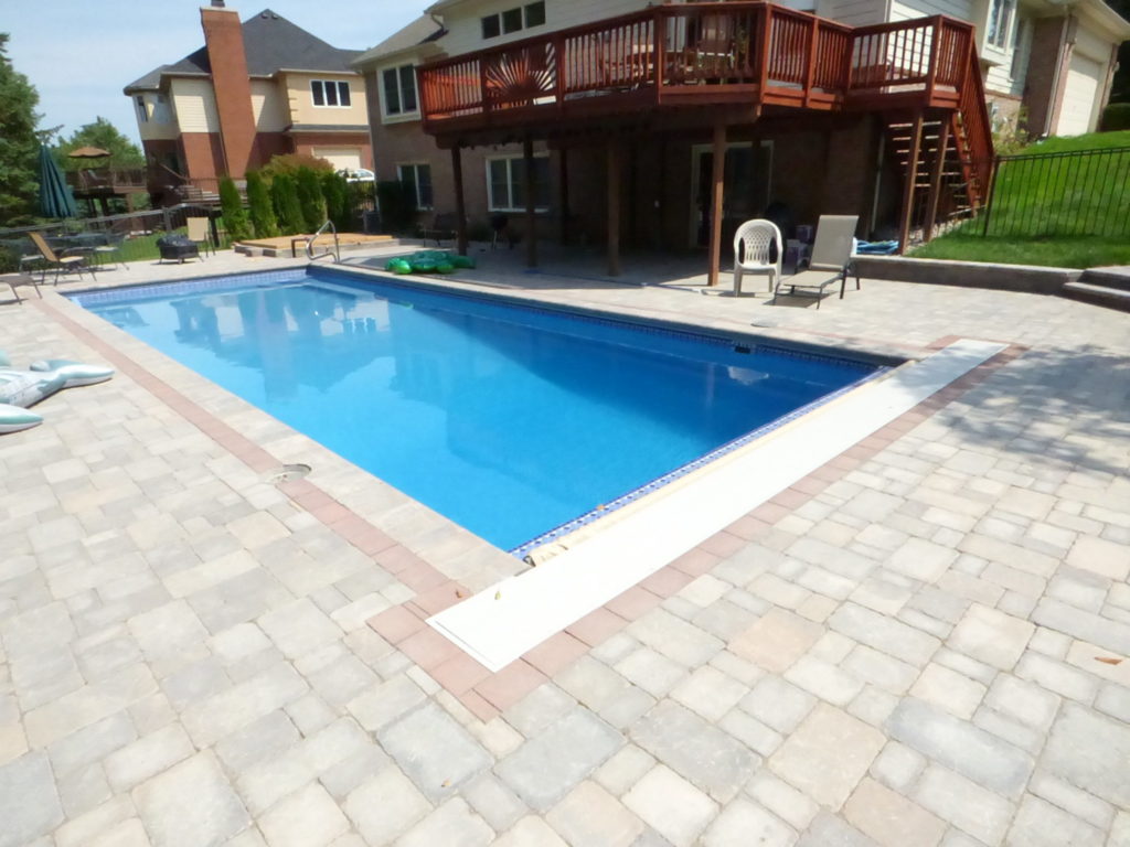 Latham fiberglass swimming pool with brick pavers surround. Commerce Mi.